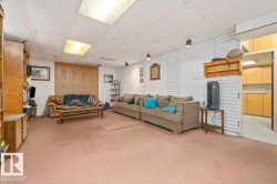 Carpeted recreation area with track lighting and drop panel ceiling - 