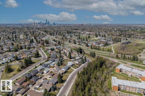 Aerial perspective showcasing a residential neighborhood with a distant cityscape - 9732 64 Street, Edmonton, AB - Outdoor With View