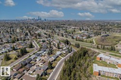 Aerial perspective showcasing a residential neighborhood with a distant cityscape - 