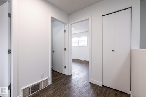 Hallway featuring wood-finish flooring and white walls - #136, 180 Bridgeport Bv, Leduc, AB - Indoor Photo Showing Other Room