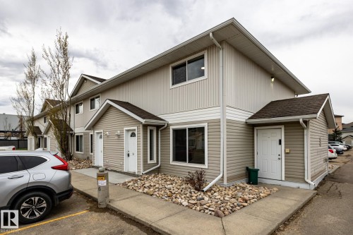 Multi-unit residence featuring beige vertical and horizontal siding - #136, 180 Bridgeport Bv, Leduc, AB - Outdoor