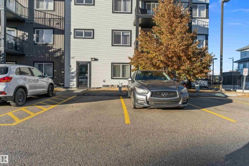 Asphalt parking area with painted yellow lines - 122 3357 16A Avenue, Edmonton, AB - Outdoor