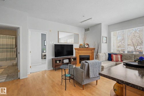 334 10023 110 Street, Edmonton, AB - Indoor Photo Showing Living Room With Fireplace