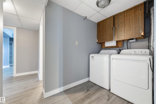 Dedicated utility area featuring wood-finish cabinetry and a drop ceiling - 6134 37A Avenue, Edmonton, AB 