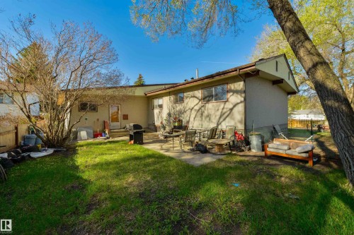 Expansive outdoor space featuring a broad lawn area and a concrete patio - 6134 37A Avenue, Edmonton, AB 
