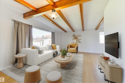 Vaulted ceiling with exposed wood beams, expansive window, light wood-finish flooring, recessed wall shelving, and a wall-mounted television - 6134 37A Avenue, Edmonton, AB 