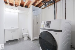 Laundry area featuring a large capacity washing machine - 
