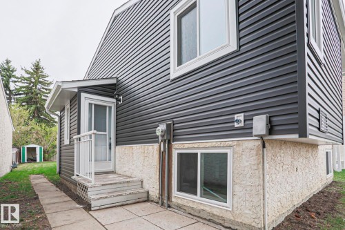 Exterior featuring dark gray horizontal siding and a stucco foundation - 35 Chungo Drive, Devon, AB - Outdoor