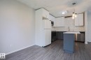 Modern kitchen featuring white upper cabinetry, gray lower cabinetry, and a subway tile backsplash - 35 Chungo Drive, Devon, AB  - Indoor Photo Showing Kitchen 