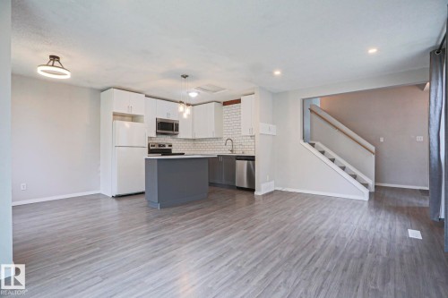 Open-concept living space featuring wood-finish flooring and recessed lighting - 35 Chungo Drive, Devon, AB - Indoor Photo Showing Kitchen
