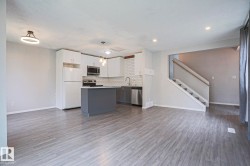 Open-concept living space featuring wood-finish flooring and recessed lighting - 