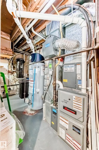 The property includes a hot water heater and a furnace - 13332 25 Street, Edmonton, AB - Indoor Photo Showing Basement
