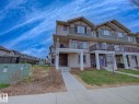 Multi-level exterior with light-colored siding and dark trim accents - 11 165 Cy Becker Boulevard, Edmonton, AB  - Outdoor With Facade 