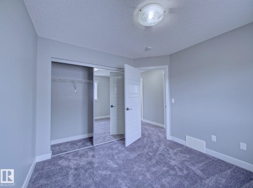 Bedroom featuring plush gray carpeting, light gray wall paint, and white trim - 11 165 Cy Becker Boulevard, Edmonton, AB - Indoor Photo Showing Other Room