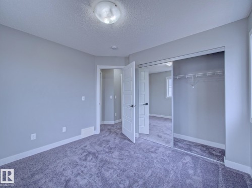 Spacious room featuring gray wall paint and plush carpeting - 11 165 Cy Becker Boulevard, Edmonton, AB - Indoor Photo Showing Other Room