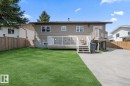 Expansive backyard featuring a green lawn, wood fencing, and a concrete patio - 1304 12 Street, Cold Lake, AB  - Outdoor With Deck Patio Veranda 