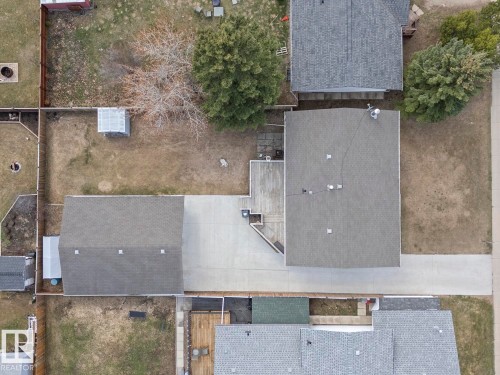 Property featuring a main residence with a gray shingle roof, an attached garage with a matching shingle roof, and a large paved driveway - 1304 12 Street, Cold Lake, AB - Outdoor