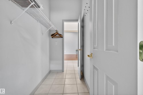 Entryway featuring tile flooring, white panel doors, and a built-in wire shelving unit - 201 Erin Ridge Drive, St. Albert, AB - Indoor Photo Showing Other Room