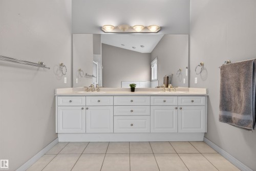 Double vanity with white cabinetry, dual sinks, and a light-toned countertop - 201 Erin Ridge Drive, St. Albert, AB - Indoor Photo Showing Bathroom