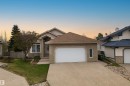 Front exterior featuring a brick facade, attached two-car garage, and a concrete driveway - 201 Erin Ridge Drive, St. Albert, AB  - Outdoor 