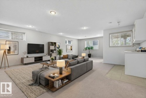 Spacious lower-level living area with recessed lighting, multiple windows, and light-toned carpeting - 201 Erin Ridge Drive, St. Albert, AB - Indoor Photo Showing Living Room