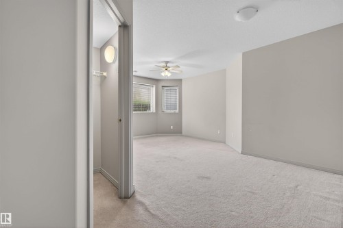 Carpeted room with a ceiling fan, recessed lighting, and multiple windows featuring blinds - 201 Erin Ridge Drive, St. Albert, AB - Indoor Photo Showing Other Room