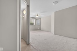 Carpeted room with a ceiling fan, recessed lighting, and multiple windows featuring blinds - 