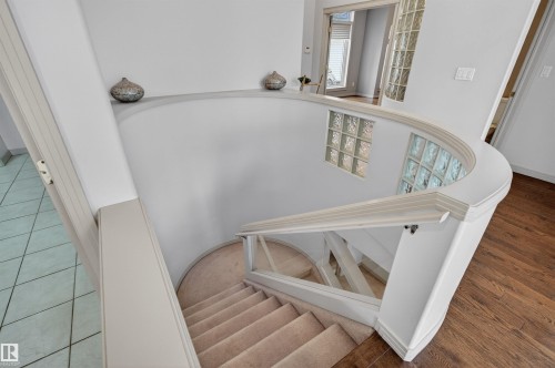 Curved staircase featuring carpeted treads and a painted railing system - 201 Erin Ridge Drive, St. Albert, AB - Indoor Photo Showing Other Room
