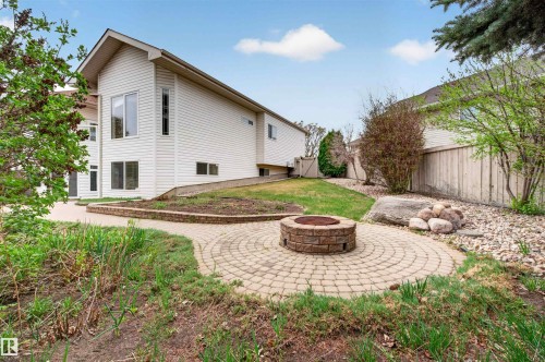 Exterior siding residence featuring a paver patio with a built-in stone fire pit - 201 Erin Ridge Drive, St. Albert, AB - Outdoor