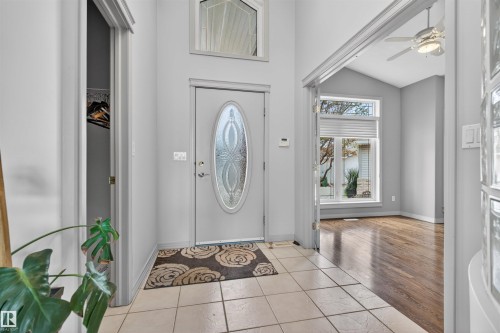 Foyer featuring a decorative glass oval front door, tiled flooring, and a soaring vaulted ceiling - 201 Erin Ridge Drive, St. Albert, AB - Indoor Photo Showing Other Room