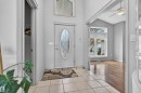 Foyer featuring a decorative glass oval front door, tiled flooring, and a soaring vaulted ceiling - 201 Erin Ridge Drive, St. Albert, AB  - Indoor Photo Showing Other Room 