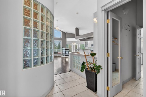 Entryway featuring light-toned tile flooring and a curved glass block wall - 201 Erin Ridge Drive, St. Albert, AB - Indoor Photo Showing Other Room