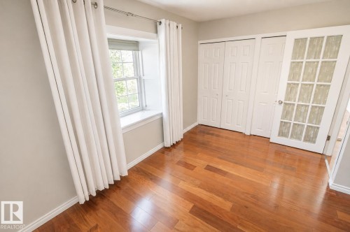 Warm wood-finish flooring complements the neutral wall tones - 4510 Lakeshore Dr, St. Paul Town, AB - Indoor Photo Showing Other Room