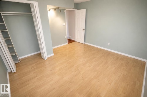 Room featuring light wood-finish flooring, light blue-grey wall paint, and white trim - 4510 Lakeshore Dr, St. Paul Town, AB - Indoor Photo Showing Other Room