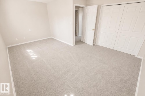 Neutral-toned carpeting spans this room, complemented by light-colored walls and white trim - 4510 Lakeshore Dr, St. Paul Town, AB - Indoor Photo Showing Other Room