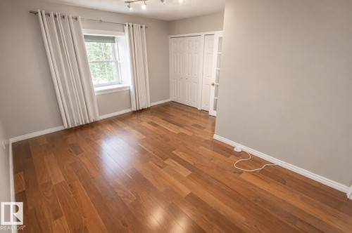 Hardwood-style flooring extends throughout this room, featuring light gray walls and white trim - 4510 Lakeshore Dr, St. Paul Town, AB - Indoor Photo Showing Other Room