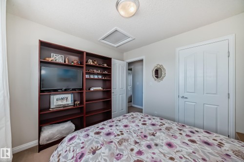 Built-in shelving unit with media niche provides integrated storage - 5333 Terwillegar Boulevard, Edmonton, AB - Indoor Photo Showing Bedroom
