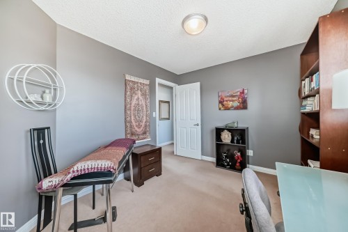 Carpeted room with neutral wall paint and a flush-mount ceiling light - 5333 Terwillegar Boulevard, Edmonton, AB - Indoor