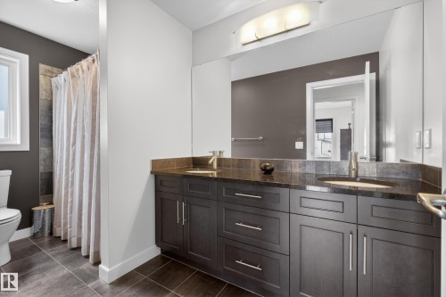 Double vanity with dark wood-finish cabinetry and silver hardware - 2760 Watcher Way, Edmonton, AB - Indoor Photo Showing Bathroom