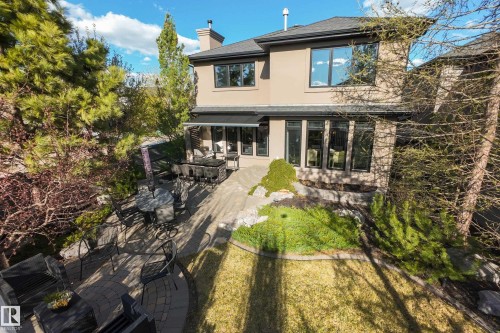 Multi-level paver patio featuring an outdoor bar area, ample seating space, and a manicured lawn - 2760 Watcher Way, Edmonton, AB - Outdoor