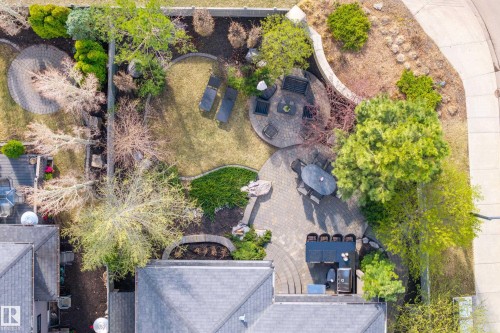 Expansive backyard featuring a paver patio, multiple seating areas, a manicured lawn, and mature trees - 2760 Watcher Way, Edmonton, AB - Outdoor With View