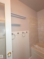 White beadboard paneling with integrated towel rings and wall-mounted shelving - 