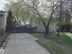 Poured concrete driveway leading to a privacy fence - 