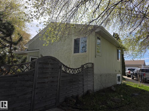 Two-story residence featuring light-toned stucco and vertical siding - 16 South Ram Crescent, Devon, AB - Outdoor