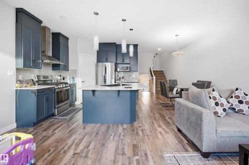 Open-concept living area featuring wood-finish flooring - 2284 Chokecherry Close, Edmonton, AB - Indoor Photo Showing Kitchen With Upgraded Kitchen