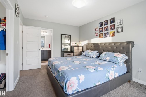 Comfortable bedroom featuring gray carpeting and light gray walls - 2284 Chokecherry Close, Edmonton, AB - Indoor Photo Showing Bedroom