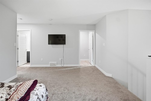 Carpeted room featuring light gray walls, white trim, and recessed lighting - 2284 Chokecherry Close, Edmonton, AB - Indoor