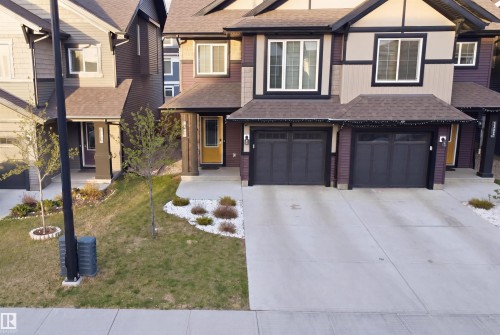 Multi-level exterior with dark siding and light trim accents - 2284 Chokecherry Close, Edmonton, AB - Outdoor With Facade