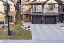Multi-level exterior with dark siding and light trim accents - 2284 Chokecherry Close, Edmonton, AB  - Outdoor With Facade 