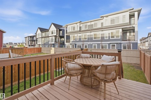 Spacious wood-finish deck featuring a wood railing with black balusters - 2284 Chokecherry Close, Edmonton, AB - Outdoor With Deck Patio Veranda With Exterior